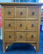 A small Chinese style chest fitted with nine drawers with ring drop handles, light wood,