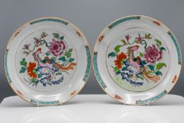 A pair of "famille-rose" Saucer Dishes, 'Qianlong,' each decorated in the centre with a phoenix