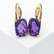 A pair of 18ct yellow gold amethyst earrings, oval faceted cut, hook clip fitting.