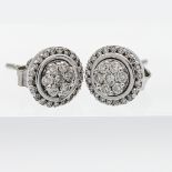 A pair of 18ct white gold stud diamond earrings in a claw setting.