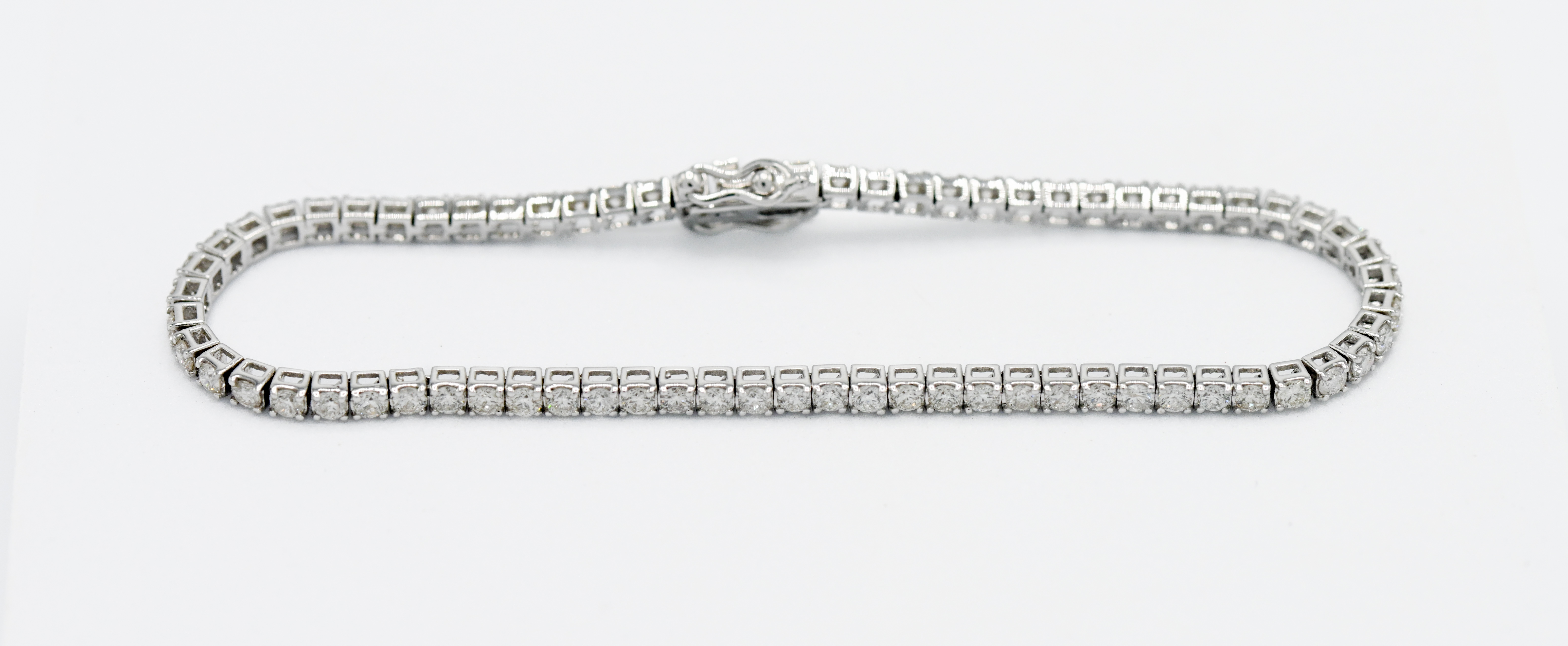 An 18ct white Tennis style gold bracelet with approx. 3ct diamonds, stud claw set, length approx.