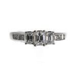 An 18ct white gold ring set centrally with three emerald cut diamonds, total weight 0.80 carats, set