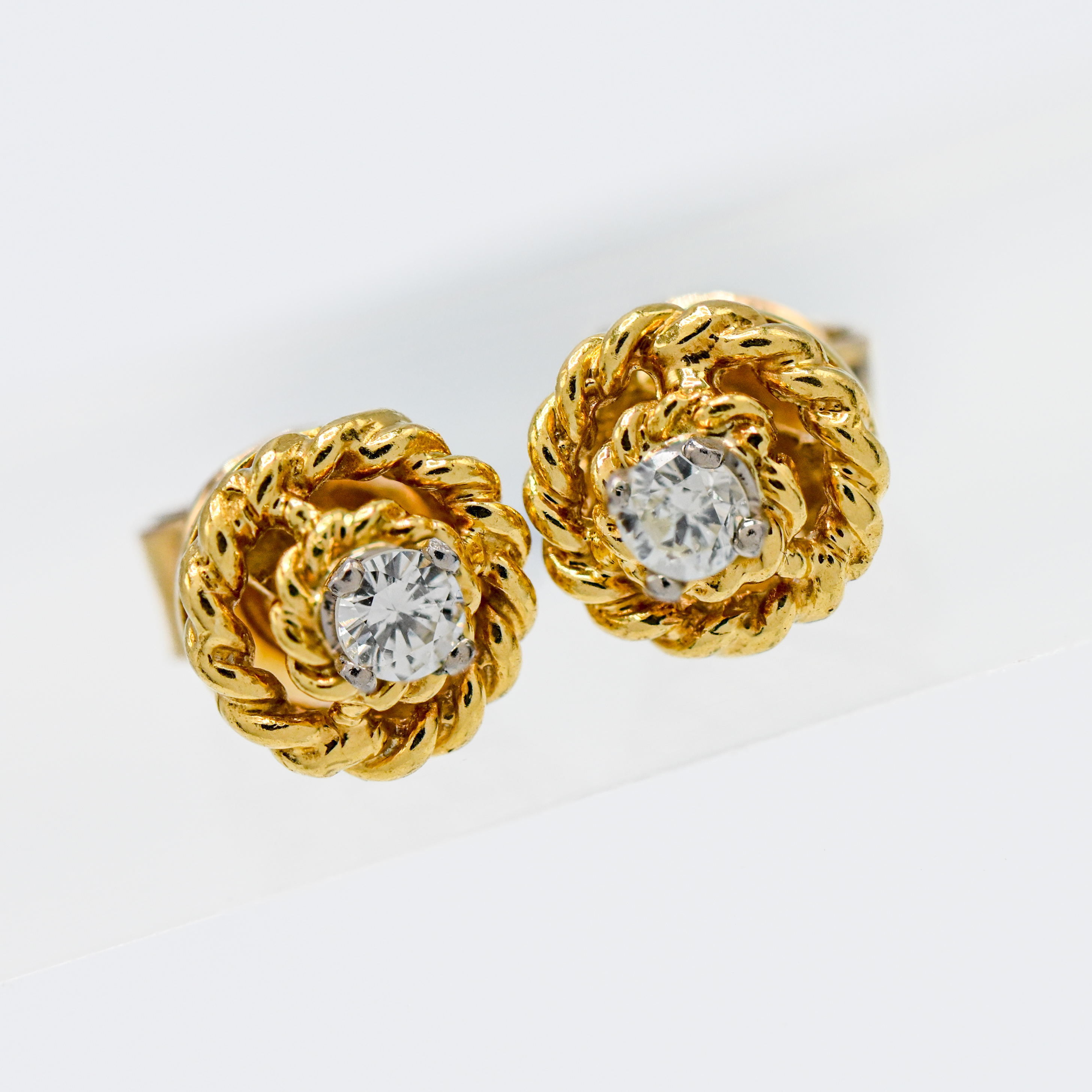A pair of 18ct yellow gold diamond rope twist earrings, approx. 0.20 total.