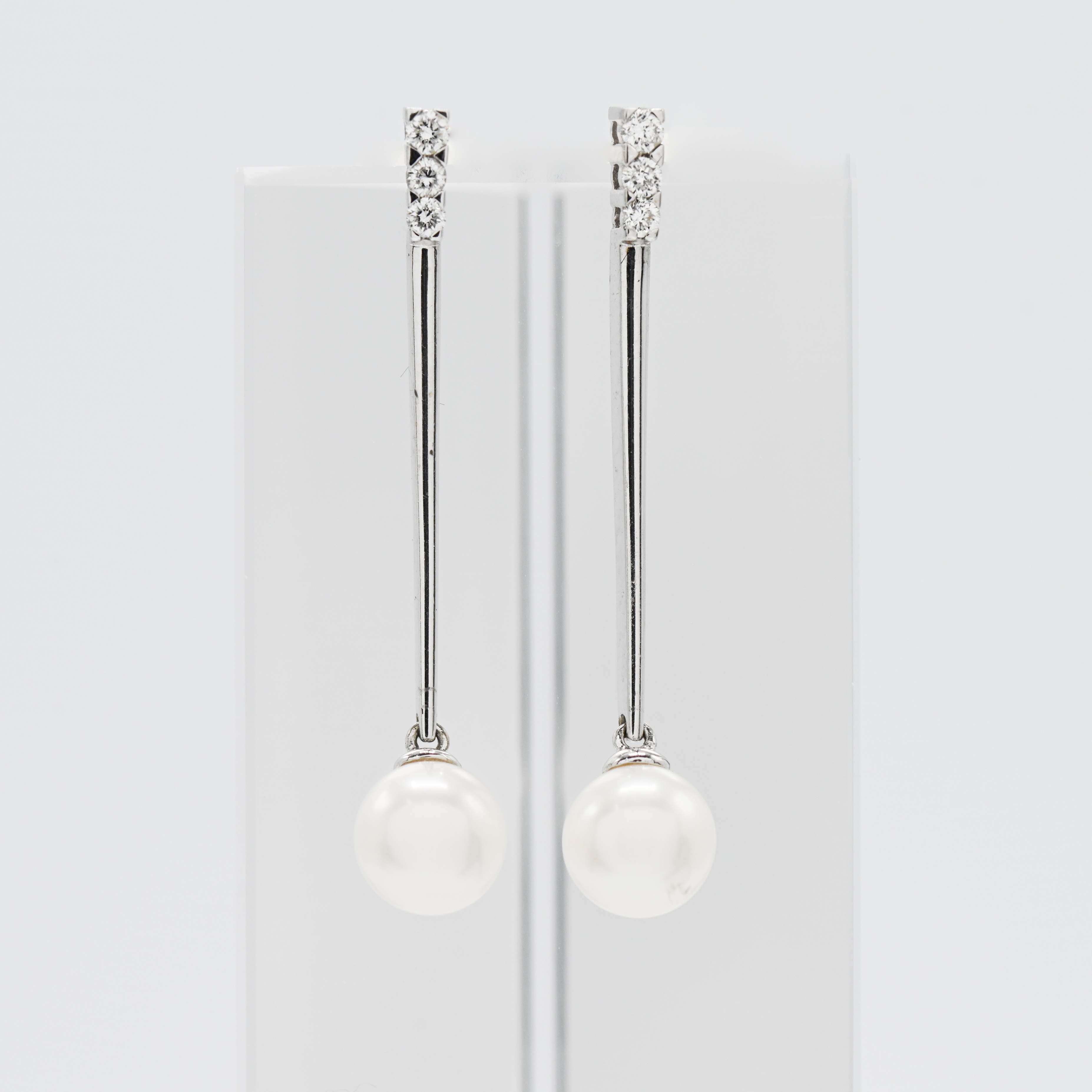 A pair of 18ct pearl and diamond drop earrings.