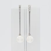 A pair of 18ct pearl and diamond drop earrings.