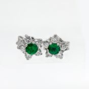 A pair of 18ct white gold 'Petal' style emerald and diamond earrings.