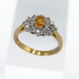 An 18ct yellow sapphire and diamond cluster ring, stamped 0.50ct diamond weight, size P/Q.