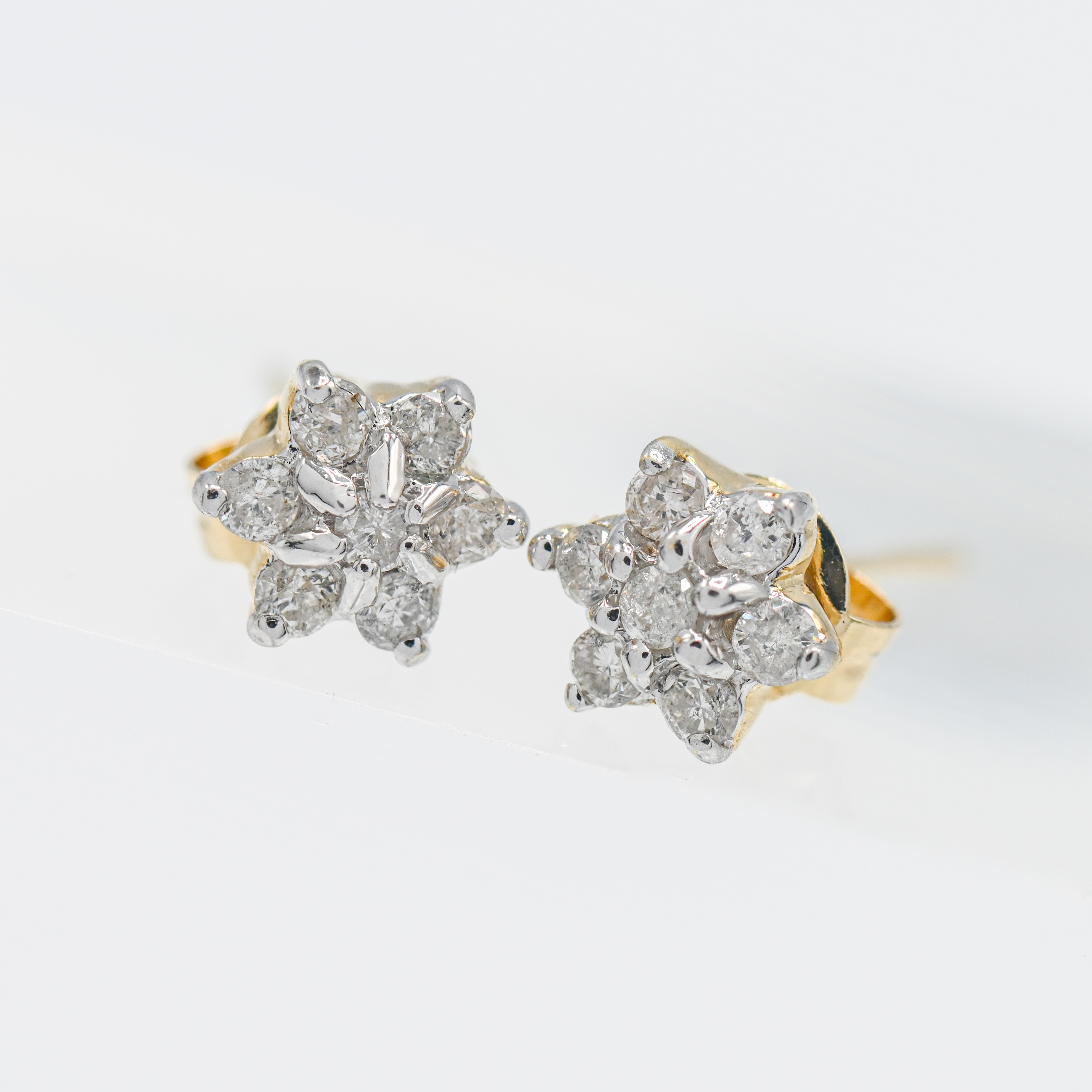 A pair of 14ct yellow gold diamond 'petal' style cluster earrings.