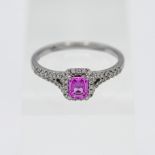 An 18ct white gold pink sapphire and diamond cluster ring, stamped 0.21ct total weight, size P.