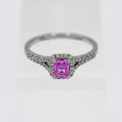 An 18ct white gold pink sapphire and diamond cluster ring, stamped 0.21ct total weight, size P.