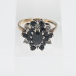 A 1970's tiered style 9ct sapphire and diamond cluster ring, size S.