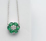 An 18ct emerald and diamond flower cluster pendant.