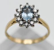 An 18ct yellow gold diamond and aquamarine cluster ring, size P.