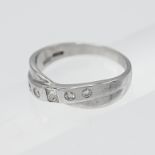 An 18ct white gold cross over diamond set half eternity ring, set with four modern brilliant and one