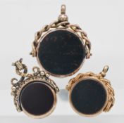 Three antique gold swivel fobs set with blood stone, the largest approx. 24mm diameter.