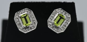 A pair of 14ct white gold diamond and peridot square earrings.