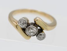 An unmarked three stone diamond twist ring, size M/N.