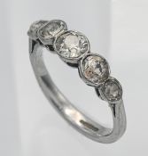 An 18ct white gold and diamond set five stone ring, rub over setting, old cut diamonds, size M/N.
