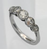 An 18ct white gold and diamond set five stone ring, rub over setting, old cut diamonds, size M/N.