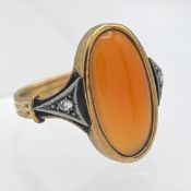 An unmarked gold hardstone and diamond set ring, the width of the table 19mm x 11mm, size L/M.