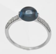 A 9k blue topaz and diamond single stone ring,