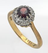 An 18ct garnet and diamond cluster ring, size N.