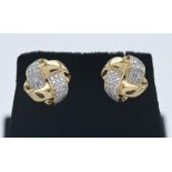 A pair of 14ct yellow gold and diamond cross over earrings.