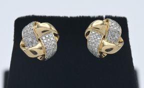 A pair of 14ct yellow gold and diamond cross over earrings.