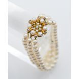 A triple row culture pearl bracelet, centre snap cluster format, 9ct yellow gold set, one pearl