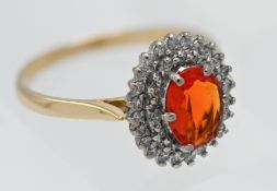 An 18ct yellow gold diamond and fire opal ring, size R.