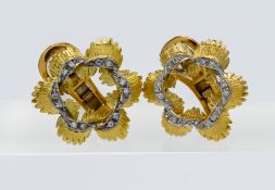 A pair of flower design earrings set with a band of diamonds, total weight approx. 11.5g.
