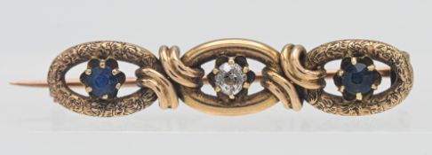 An antique sapphire and diamond set three stone brooch, width 40mm.