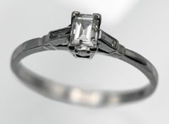 A platinum and diamond set single stone ring, set with an emerald cut diamond, size K.
