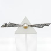 A pearl and diamond brooch set in white metal, eight/eight cut diamonds, length 53mm.