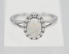 A 9ct white gold diamond and opal cluster ring, size M.