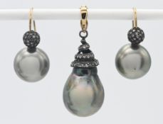 A pearl and diamond suite of jewellery comprising a pendant with spiral twist and matching