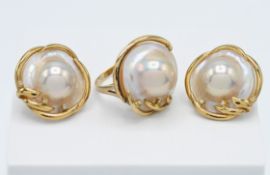 An 18ct yellow gold set of diamond blister / Mabe pearl earrings and ring set, earrings with clip