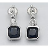 A pair of 18k white gold diamond and sapphire drop earrings, marked on both K18 0.175.