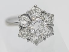 A good diamond cluster ring set in white metal probably platinum, size G.