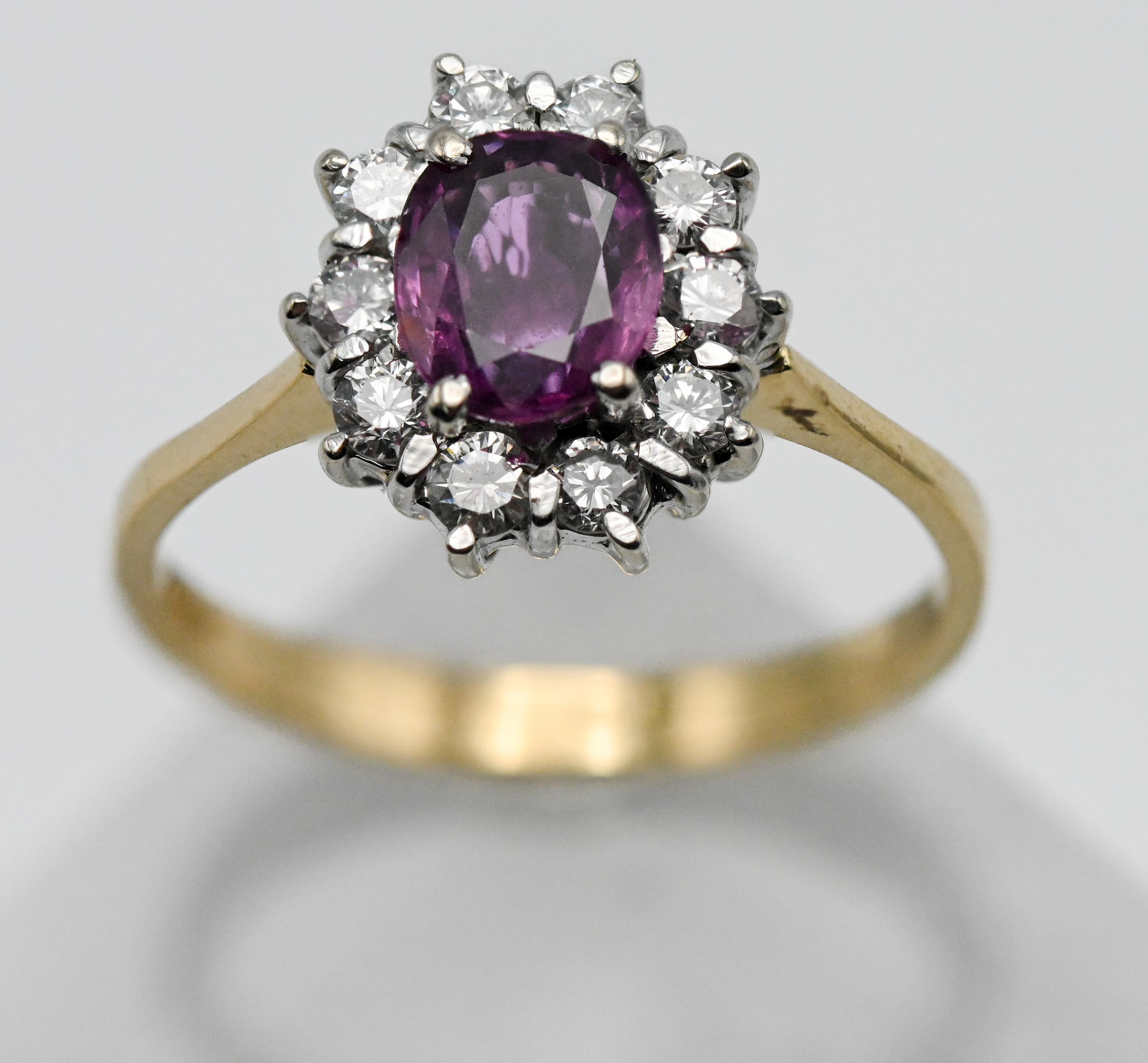 An 18ct yellow gold pink sapphire and diamond cluster ring, size P.