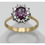 An 18ct yellow gold pink sapphire and diamond cluster ring, size P.