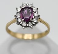 An 18ct yellow gold pink sapphire and diamond cluster ring, size P.