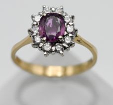 An 18ct yellow gold pink sapphire and diamond cluster ring, size P.