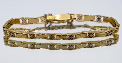 High-carat yellow gold open and bar link style bracelet with safety chain, probably 18ct, length