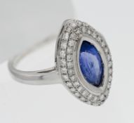 An 18ct white gold oval shape tanzanite and diamond ring, size O.