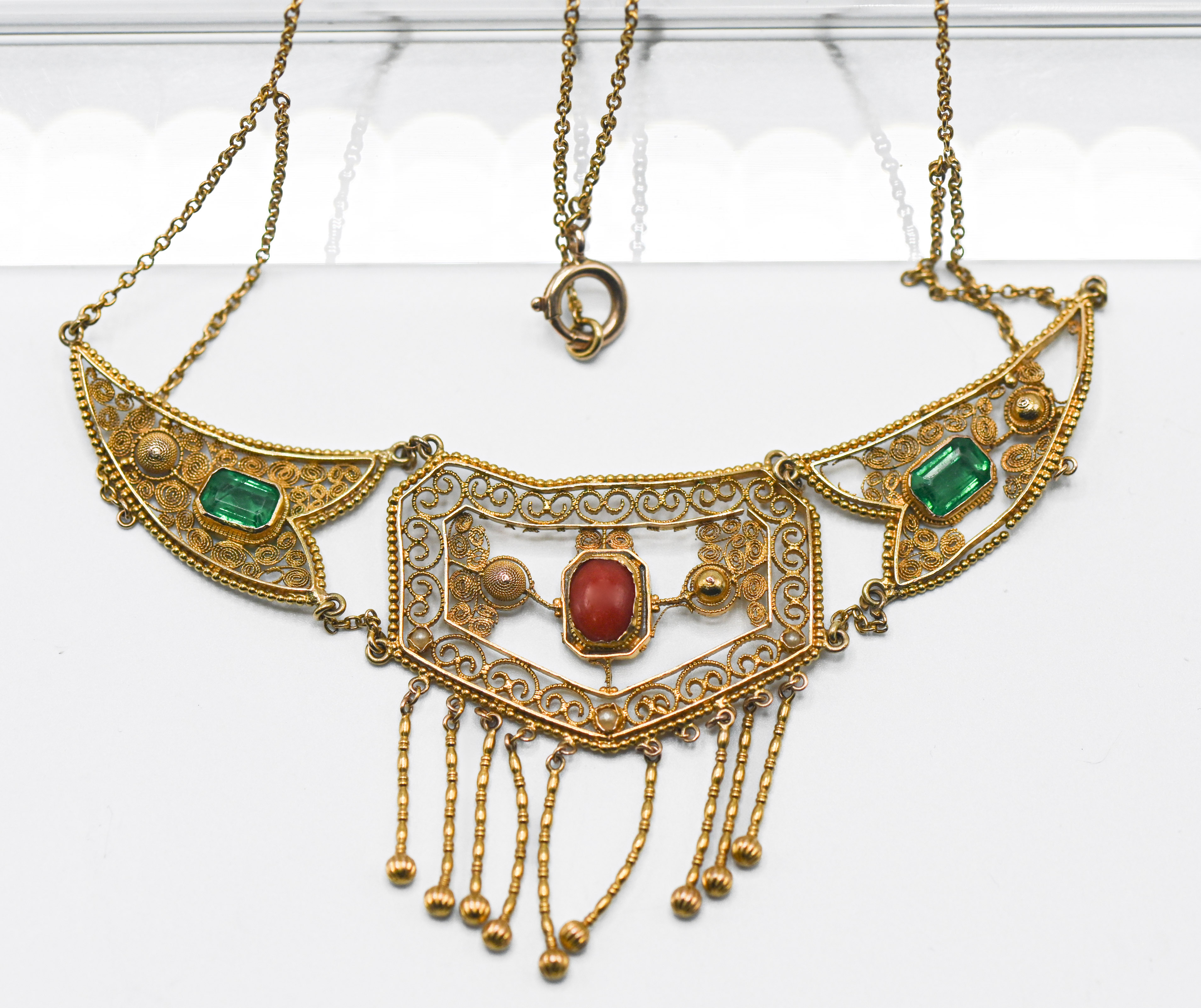 A high-carat yellow gold filigree (Indian?) gold necklet, set with emeralds and coral stones, (