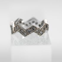 A white gold set zigzag pattern full diamond set eternity ring, not hallmarked, size J-half, total