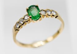 An 18ct emerald and diamond ring, size L.