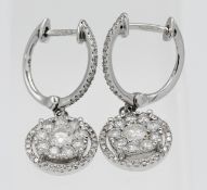 A pair of 9ct white gold and diamond drop earrings.