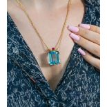 An impressive 14ct gold Aquamarine and Ruby pendant, set with one blue aquamarine with a pale tone